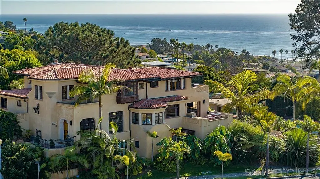 Luxury house California real estate by the ocean with green plants around.