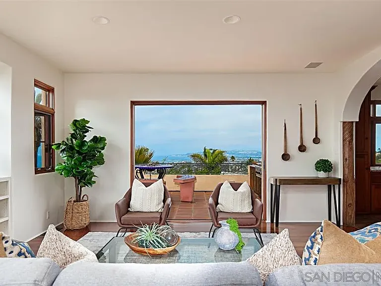 Bright sitting area with large picture window and scenic coastal views