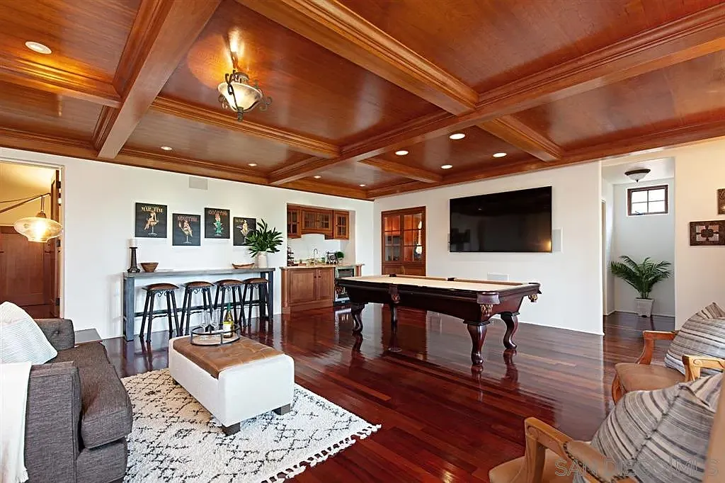 Elegant living room with vaulted wooden ceiling and exposed beams