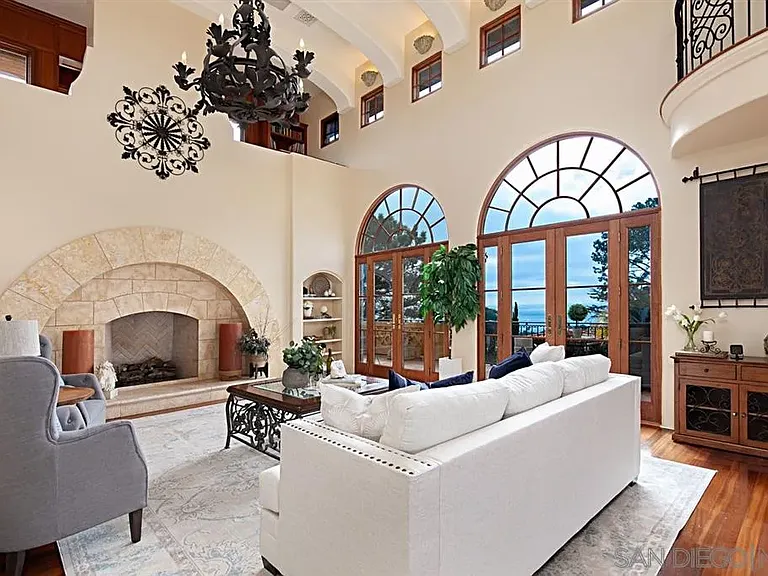 Elegant double-height living room with fireplace and arched windows