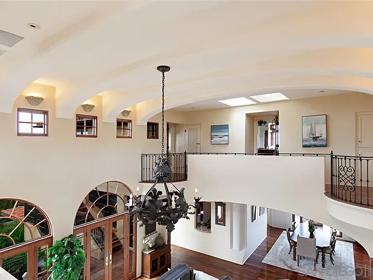 Elegant Mediterranean-style interior with vaulted ceilings and decorative chandelier