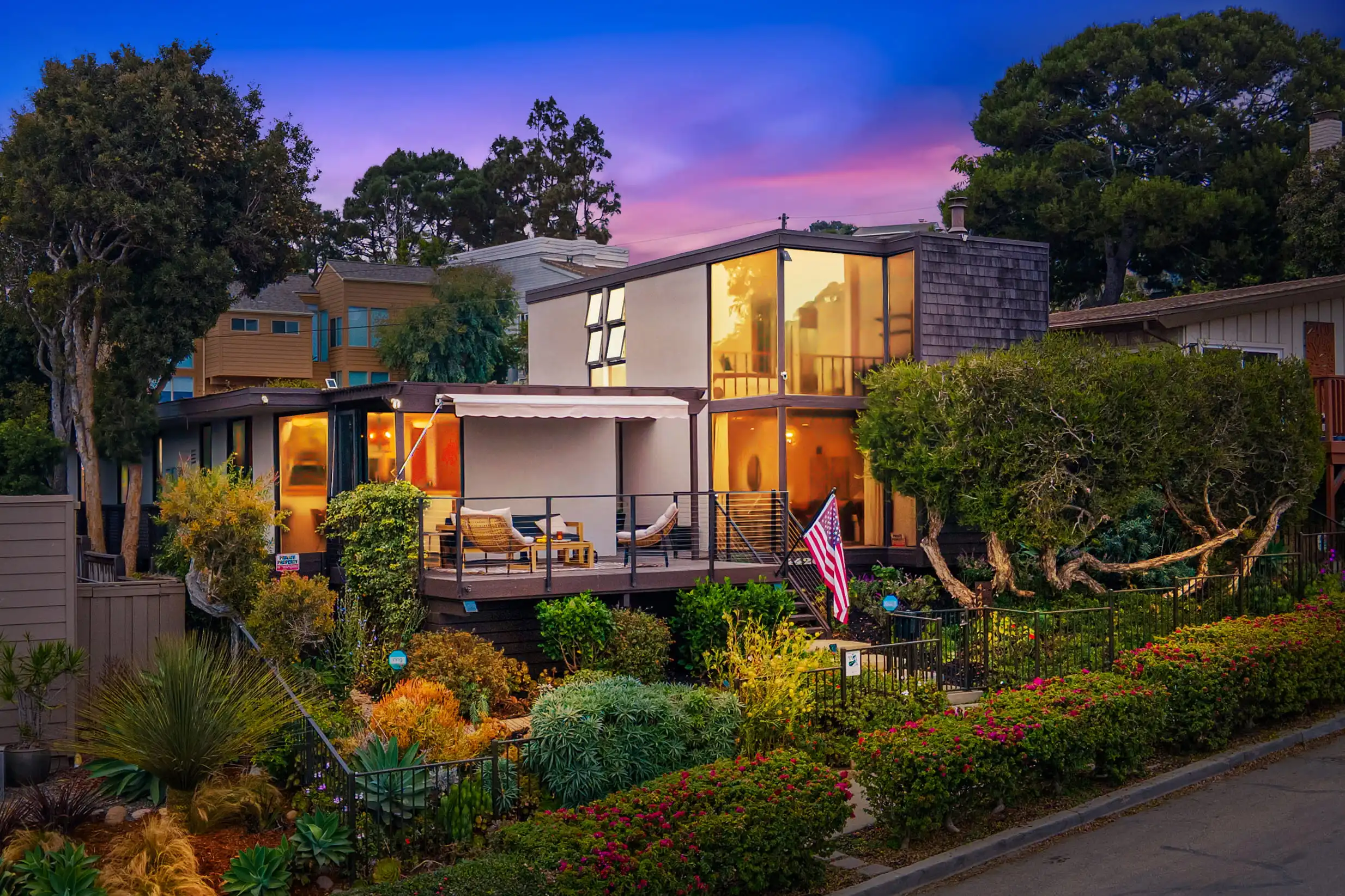Modern home at 4420 Ladera Street illuminated at dusk