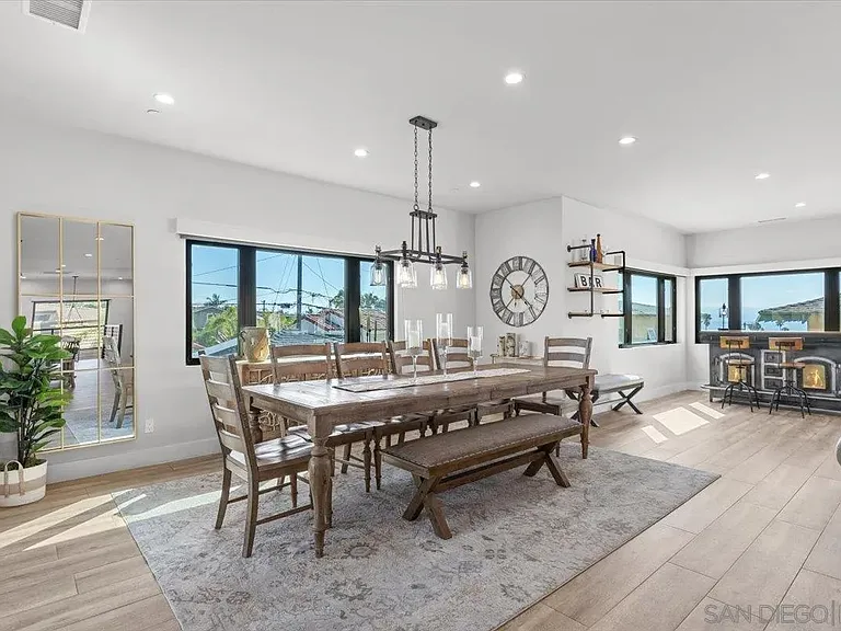 Contemporary dining room with large glass doors overlooking the backyard