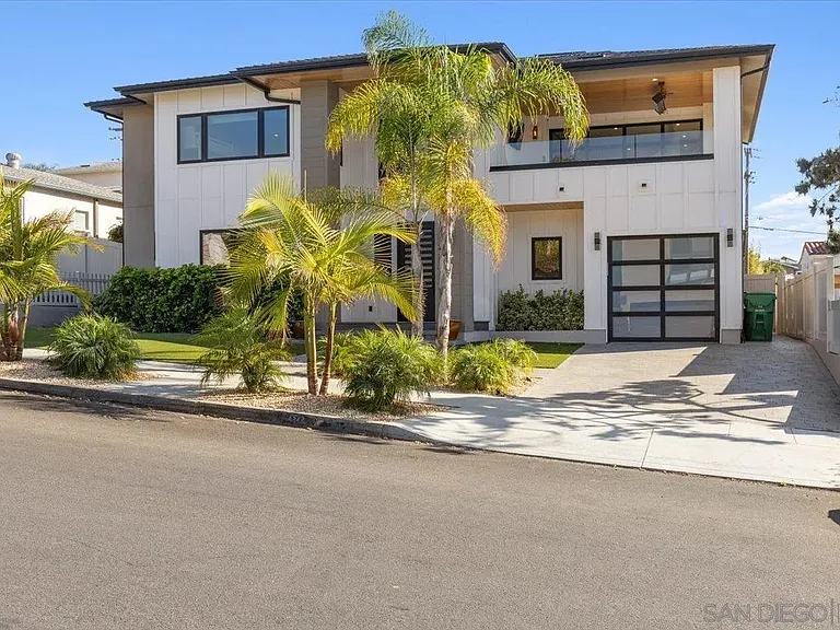 Modern residential property with spacious driveway and tropical landscaping