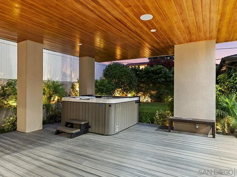 Covered rooftop lounge with built-in cabinetry and scenic neighborhood views