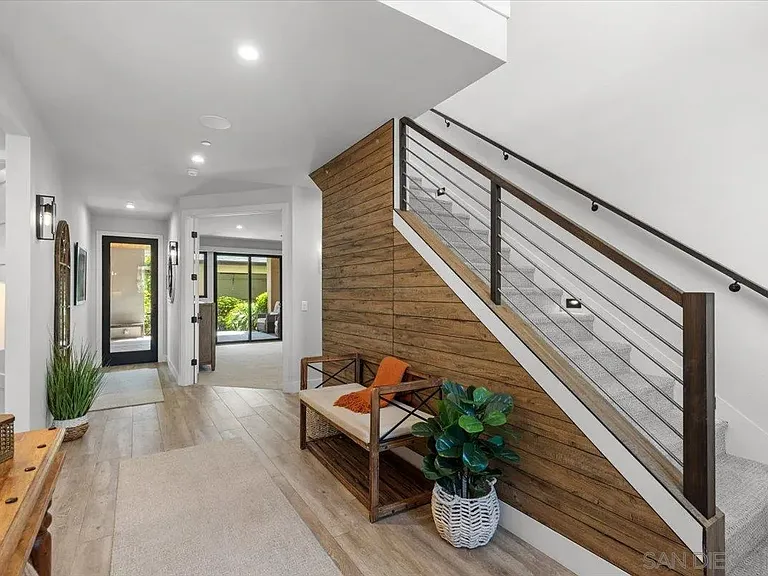 Modern entryway with staircase and contemporary finishes at 4515 Tivoli Street