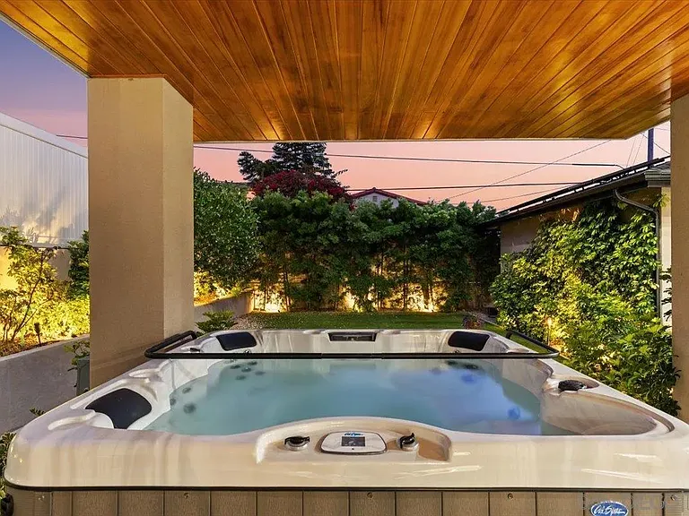 Private outdoor spa beneath a covered wood-paneled patio at 4515 Tivoli Street