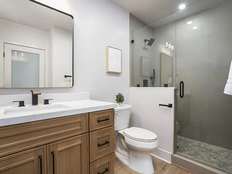 Modern white bathroom with walk-in glass shower at 4593 Coronado Avenue